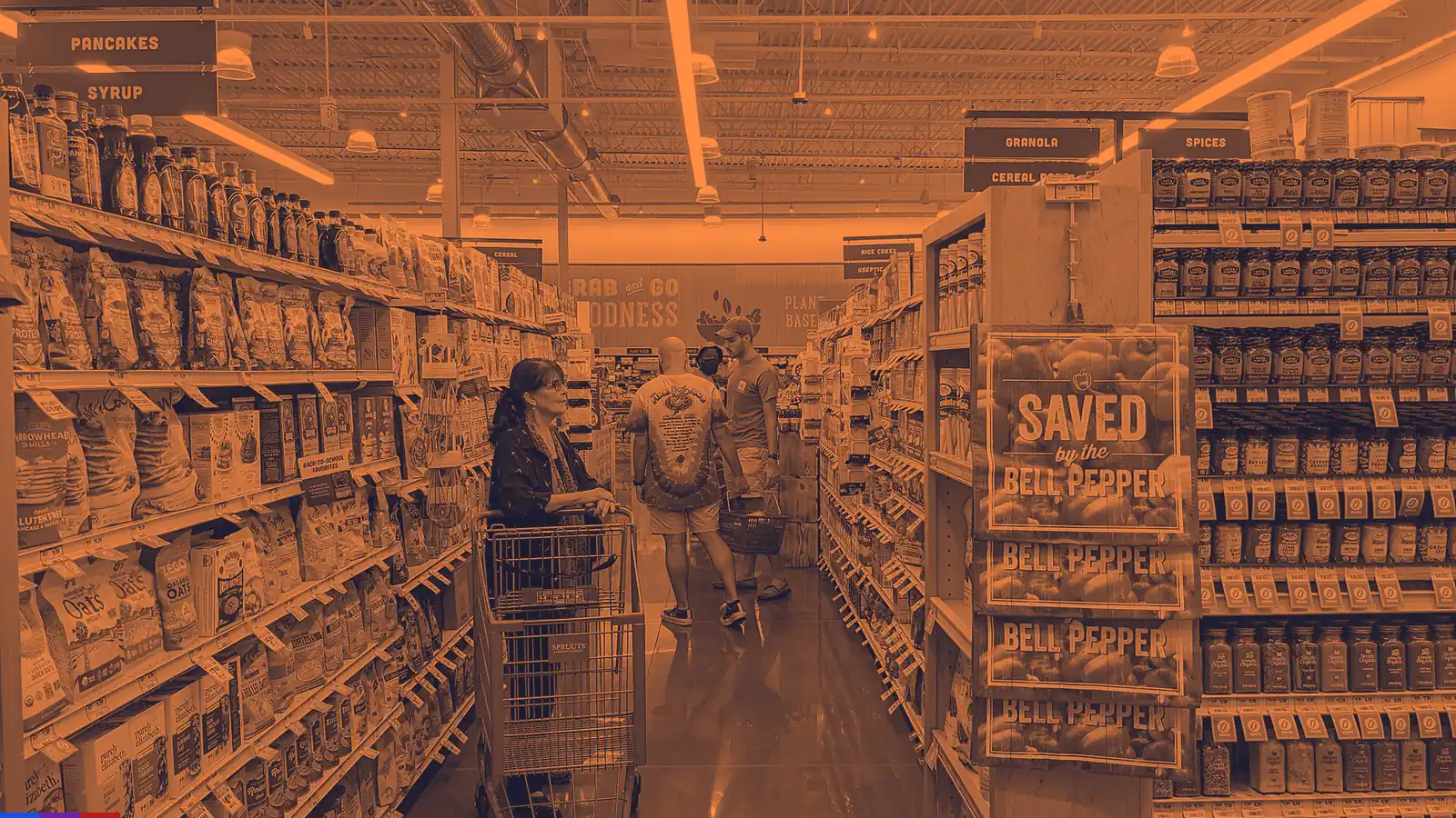 Orange-and-ink duotone of a grocery store aisle